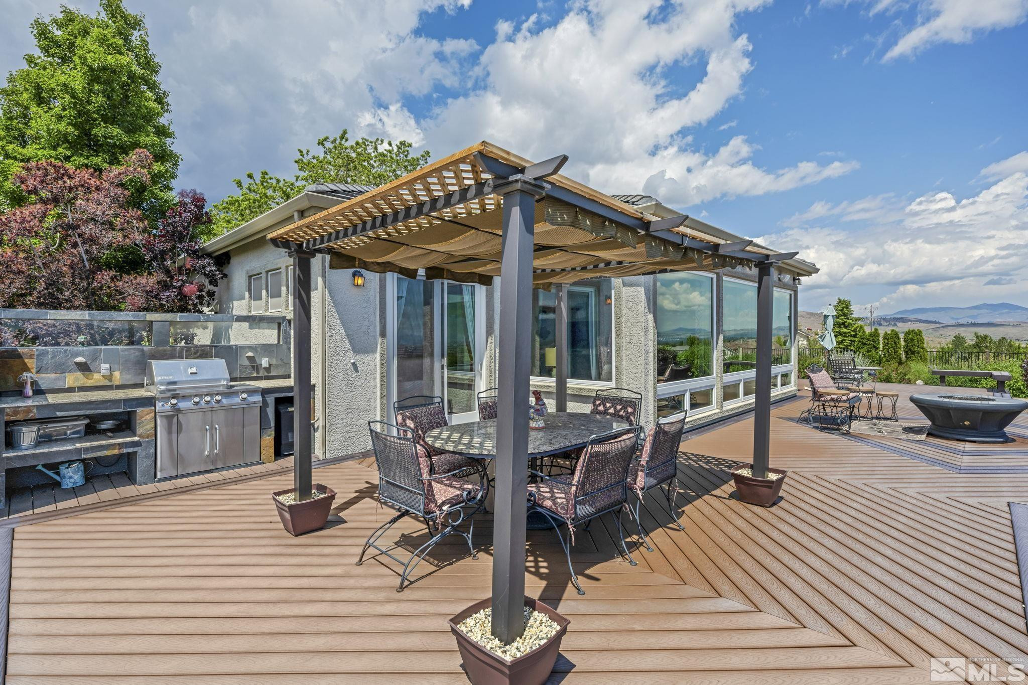 6824 Marble Canyon Road Reno, NV 89511 - Photo 24 of 30 a view of a patio with table and chairs and wooden floor