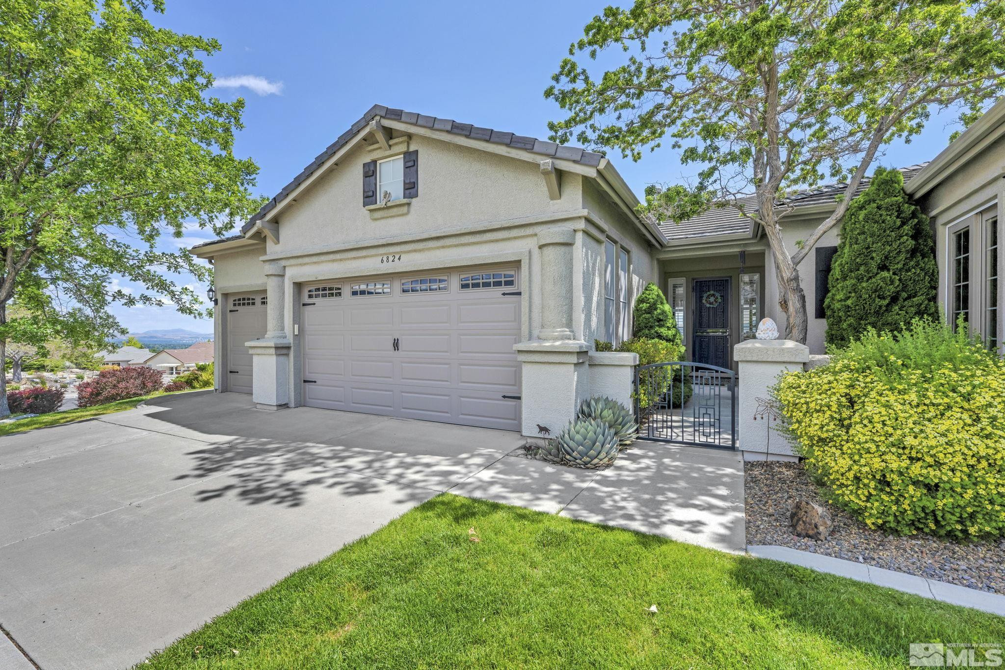 6824 Marble Canyon Road Reno, NV 89511 - Photo 5 of 30 a front view of a house with a yard and garage