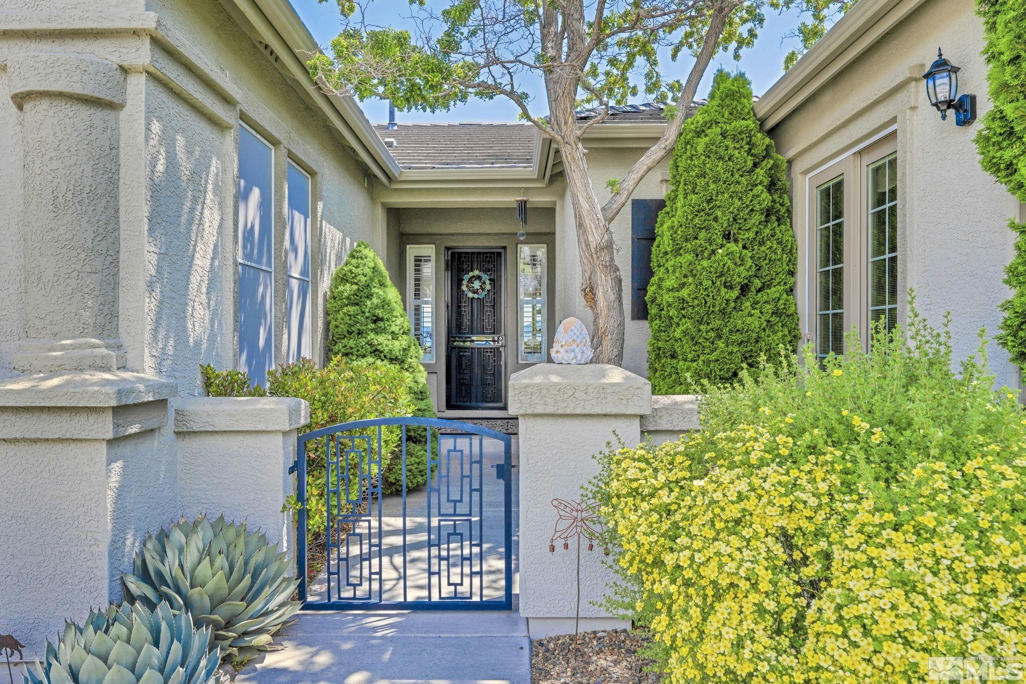 6824 Marble Canyon Road Reno, NV 89511 - Photo 6 of 30 a front view of a house with a garden