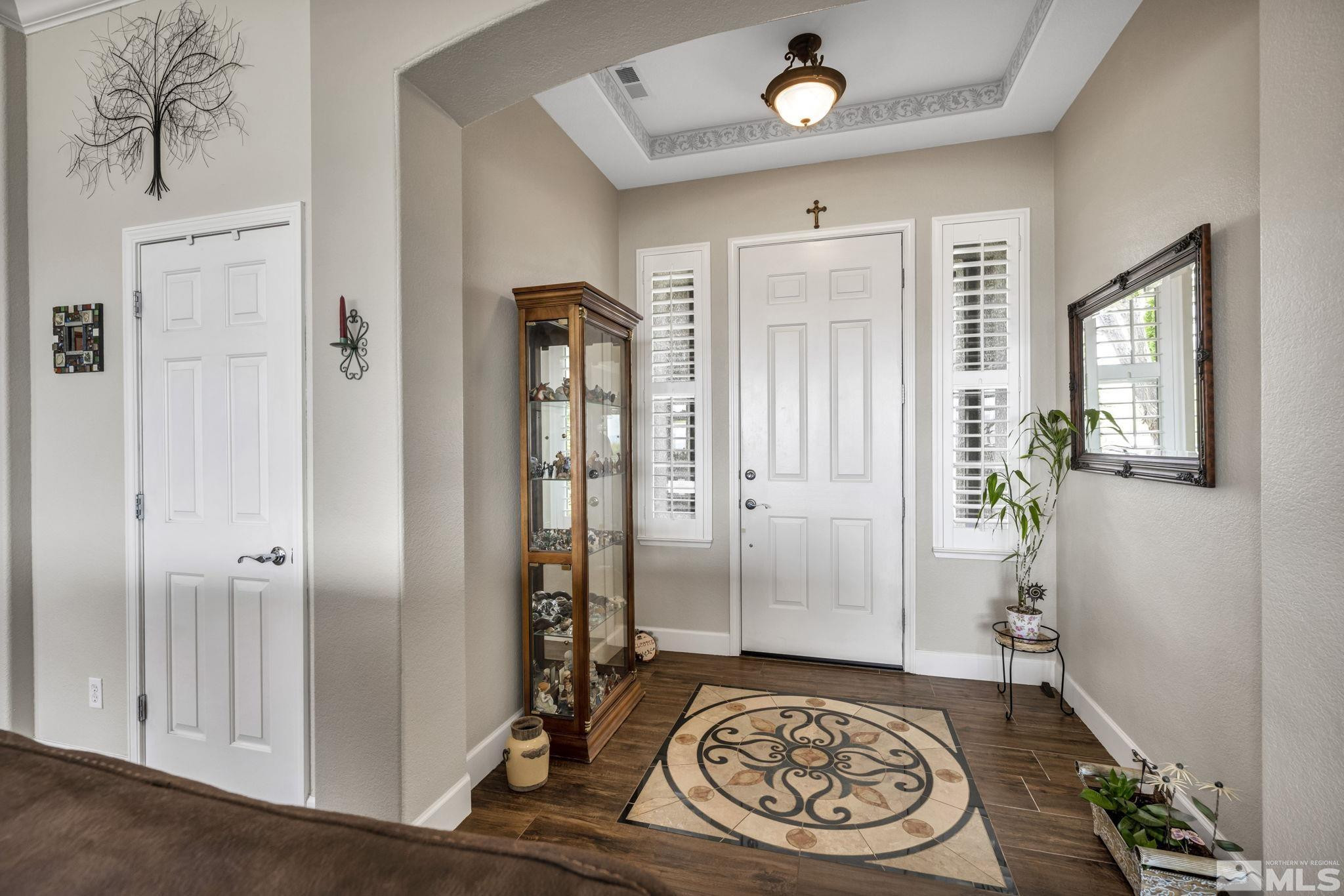 6824 Marble Canyon Road Reno, NV 89511 - Photo 7 of 30 a view of a hallway with wooden floor and a livingroom