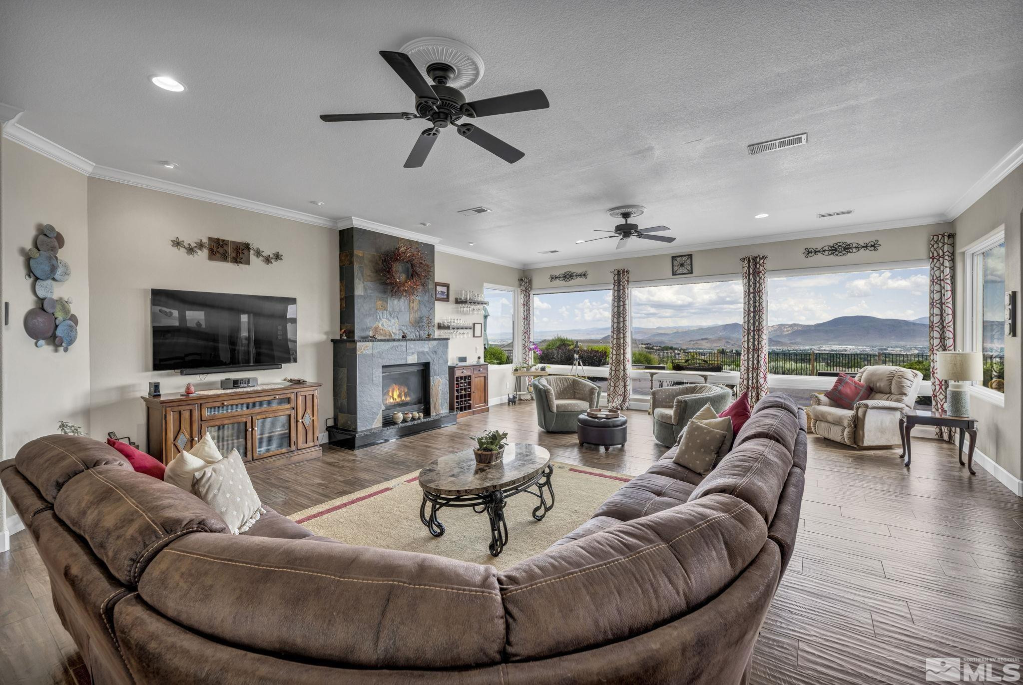 6824 Marble Canyon Road Reno, NV 89511 - Photo 8 of 30 a living room with furniture a flat screen tv and a large window