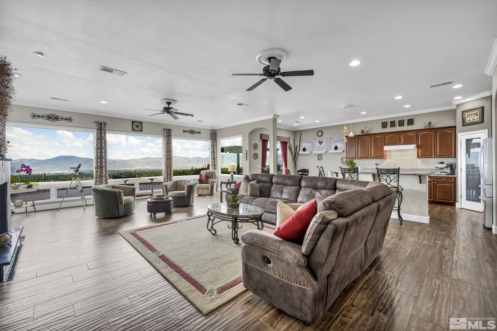 6824 Marble Canyon Road Reno, NV 89511 - Photo 9 of 30 a living room with furniture kitchen view and a wooden floor