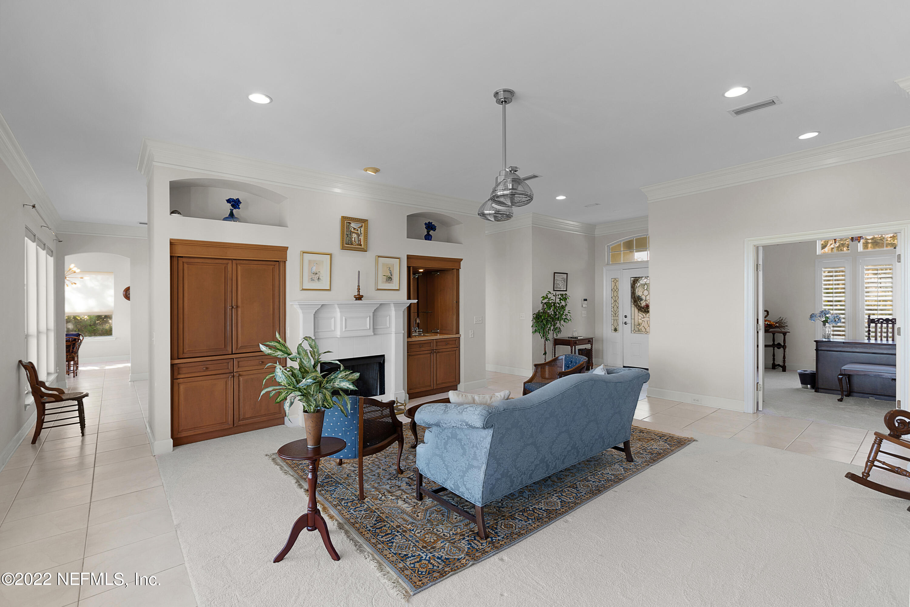 13263 Fort Caroline Road Jacksonville, FL 32225 - Photo 12 of 64 a living room with furniture and a chandelier