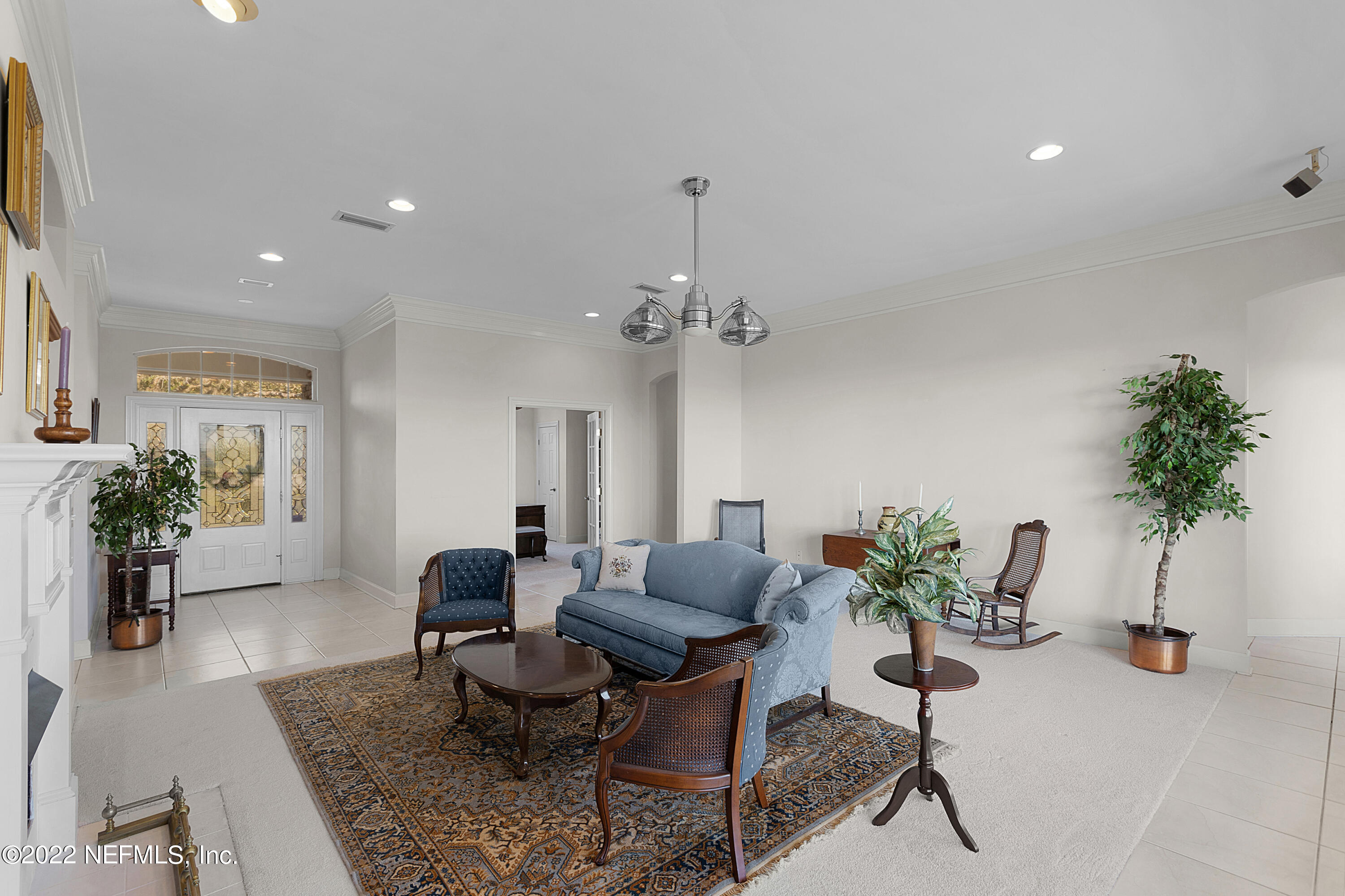 13263 Fort Caroline Road Jacksonville, FL 32225 - Photo 13 of 64 a living room with furniture flowers and a potted plant