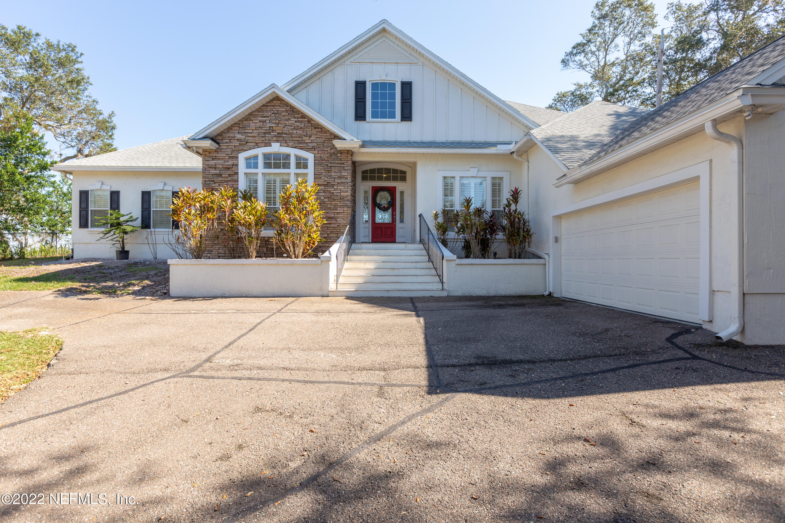 13263 Fort Caroline Road Jacksonville, FL 32225 - Photo 2 of 64 a front view of a house with a yard and garage
