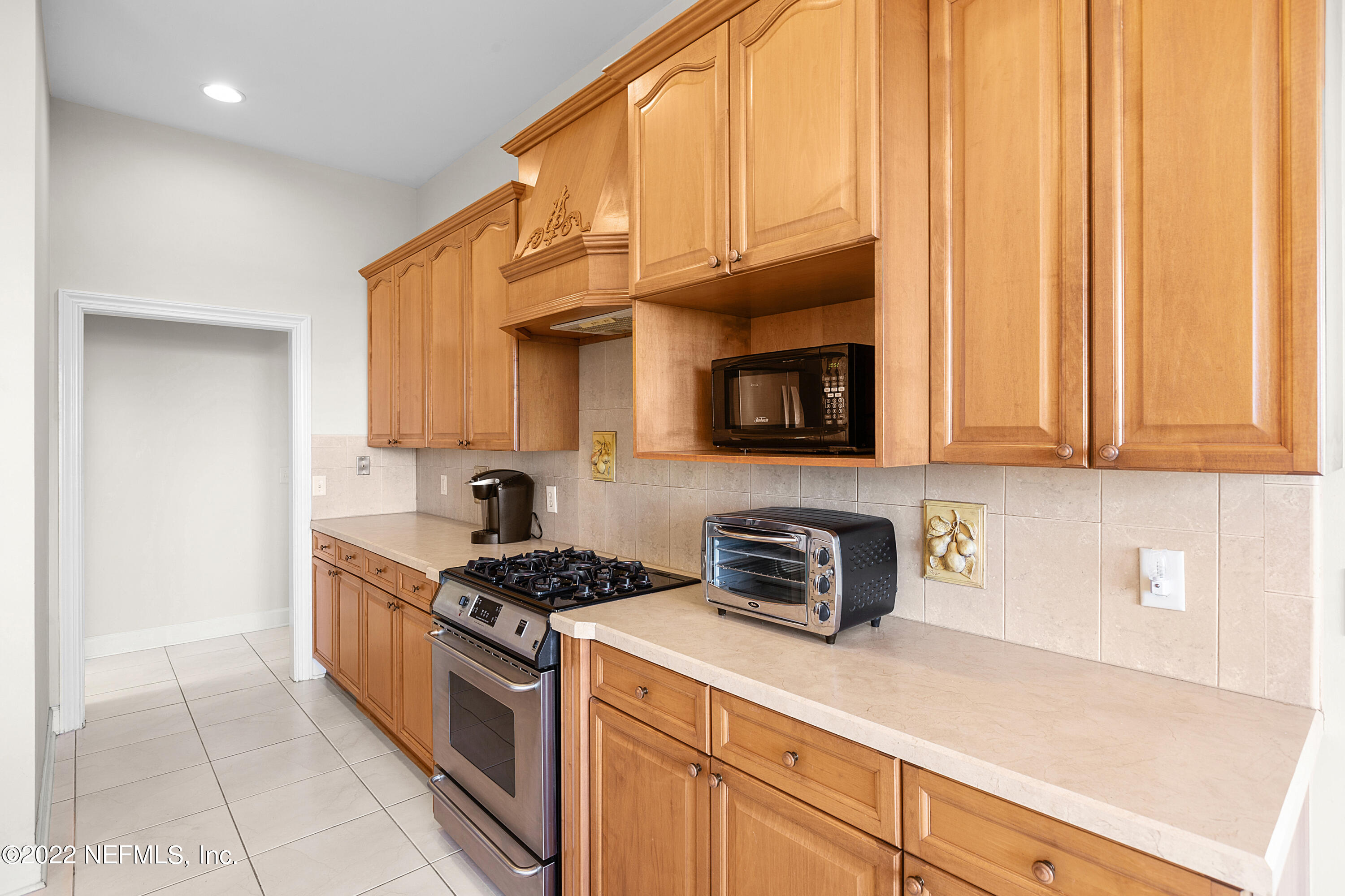 13263 Fort Caroline Road Jacksonville, FL 32225 - Photo 22 of 64 a kitchen with stainless steel appliances granite countertop a sink a stove and a microwave
