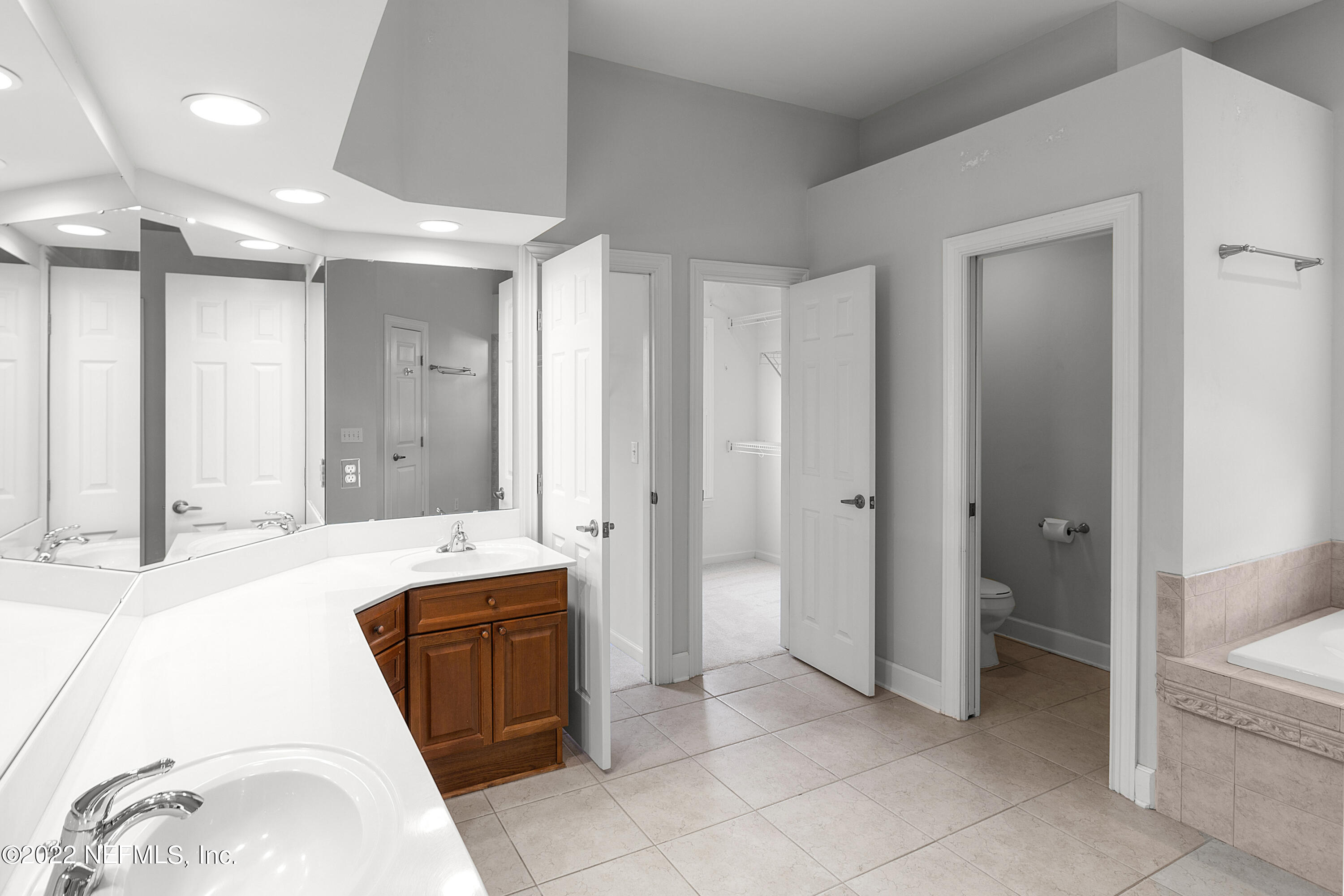 13263 Fort Caroline Road Jacksonville, FL 32225 - Photo 28 of 64 a spacious bathroom with a granite countertop sink a mirror and a bathtub