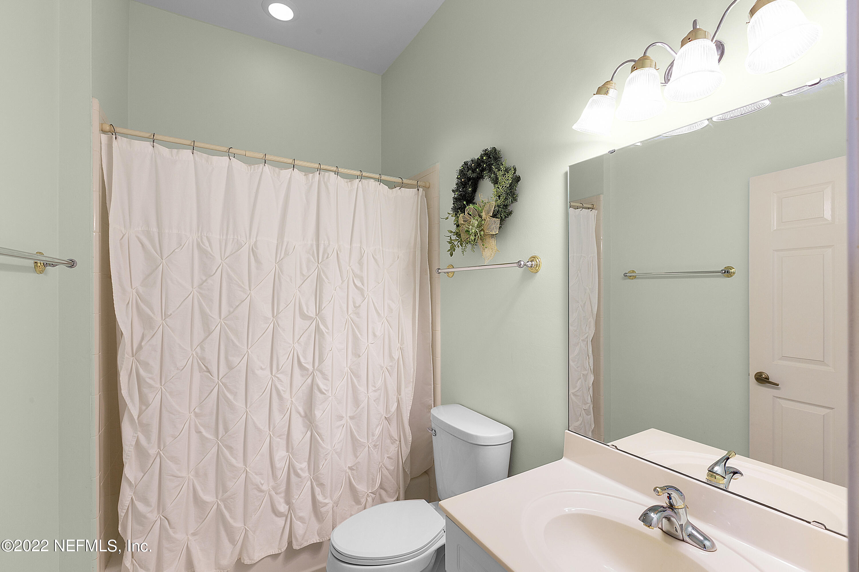 13263 Fort Caroline Road Jacksonville, FL 32225 - Photo 35 of 64 a bathroom with a sink a toilet and shower curtain