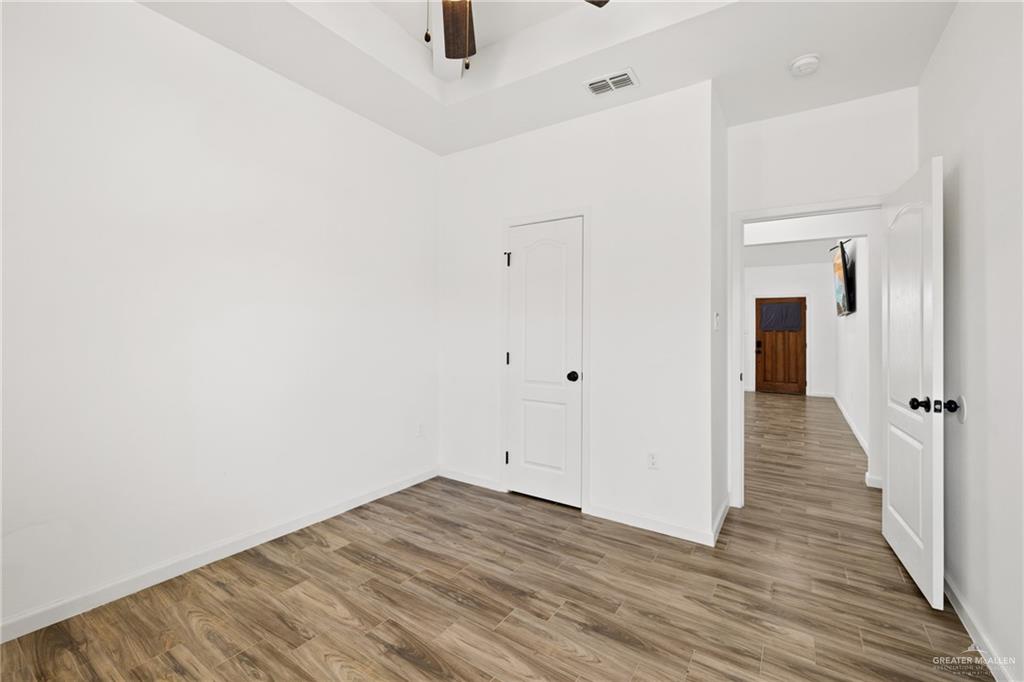 6007 Reymundo Street Edinburg, TX 78542 - Photo 10 of 17 a view of a hallway with wooden floor