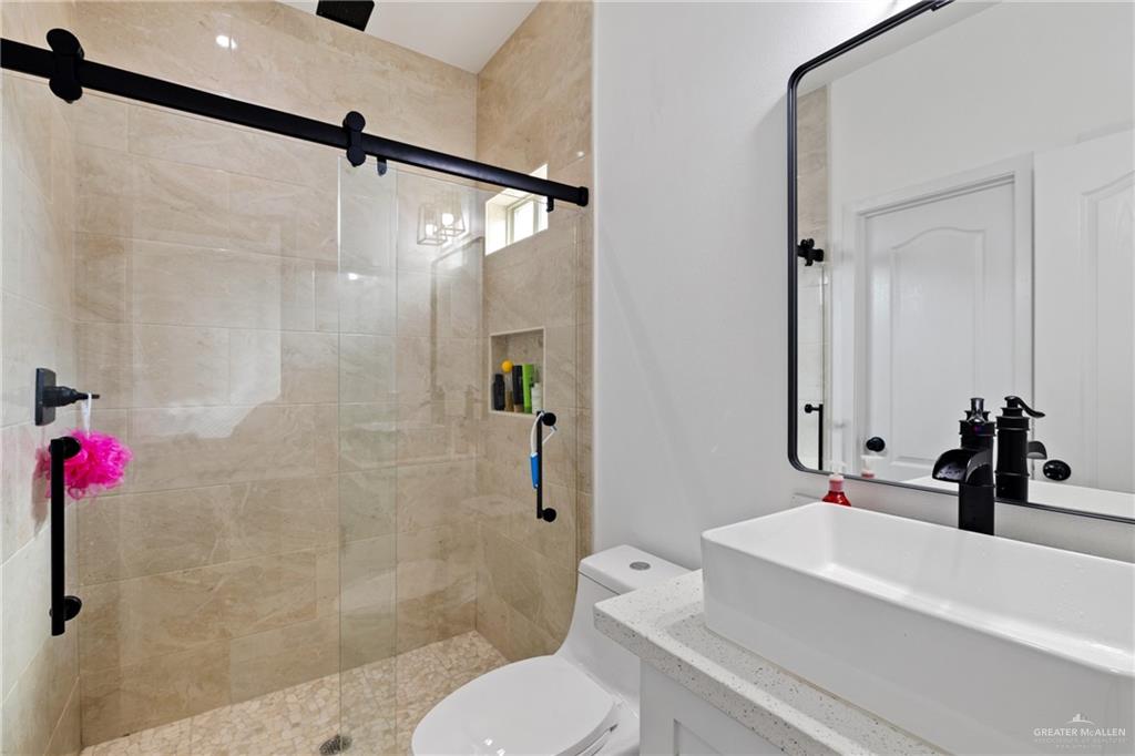 6007 Reymundo Street Edinburg, TX 78542 - Photo 13 of 17 a bathroom with a sink toilet and shower