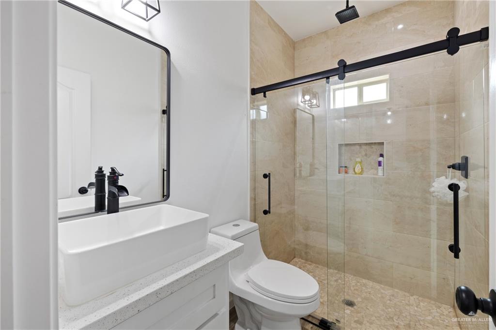 6007 Reymundo Street Edinburg, TX 78542 - Photo 14 of 17 a bathroom with a sink toilet and shower