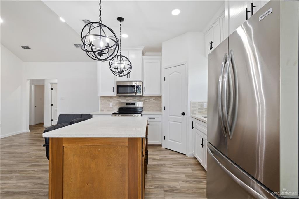 6007 Reymundo Street Edinburg, TX 78542 - Photo 5 of 17 a kitchen with stainless steel appliances a refrigerator sink and cabinets
