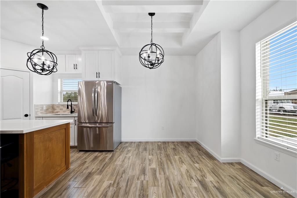 6007 Reymundo Street Edinburg, TX 78542 - Photo 6 of 17 a view of a kitchen with fridge and wooden floor