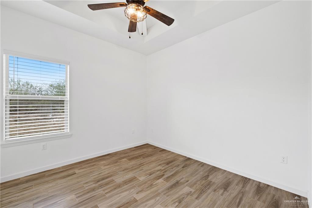 6007 Reymundo Street Edinburg, TX 78542 - Photo 9 of 17 wooden floor in an empty room with a window