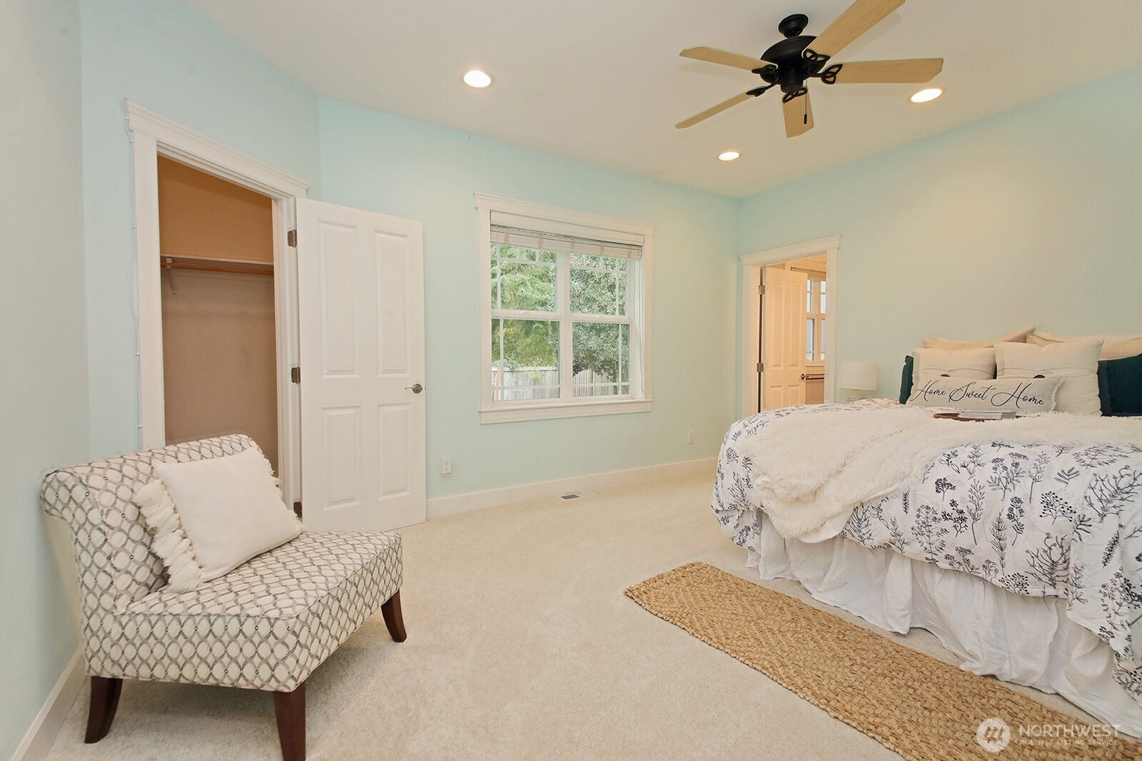 1821 Watkins Road Freeland, WA 98249 - Photo 11 of 28 a spacious bedroom with a bed a couch and a window