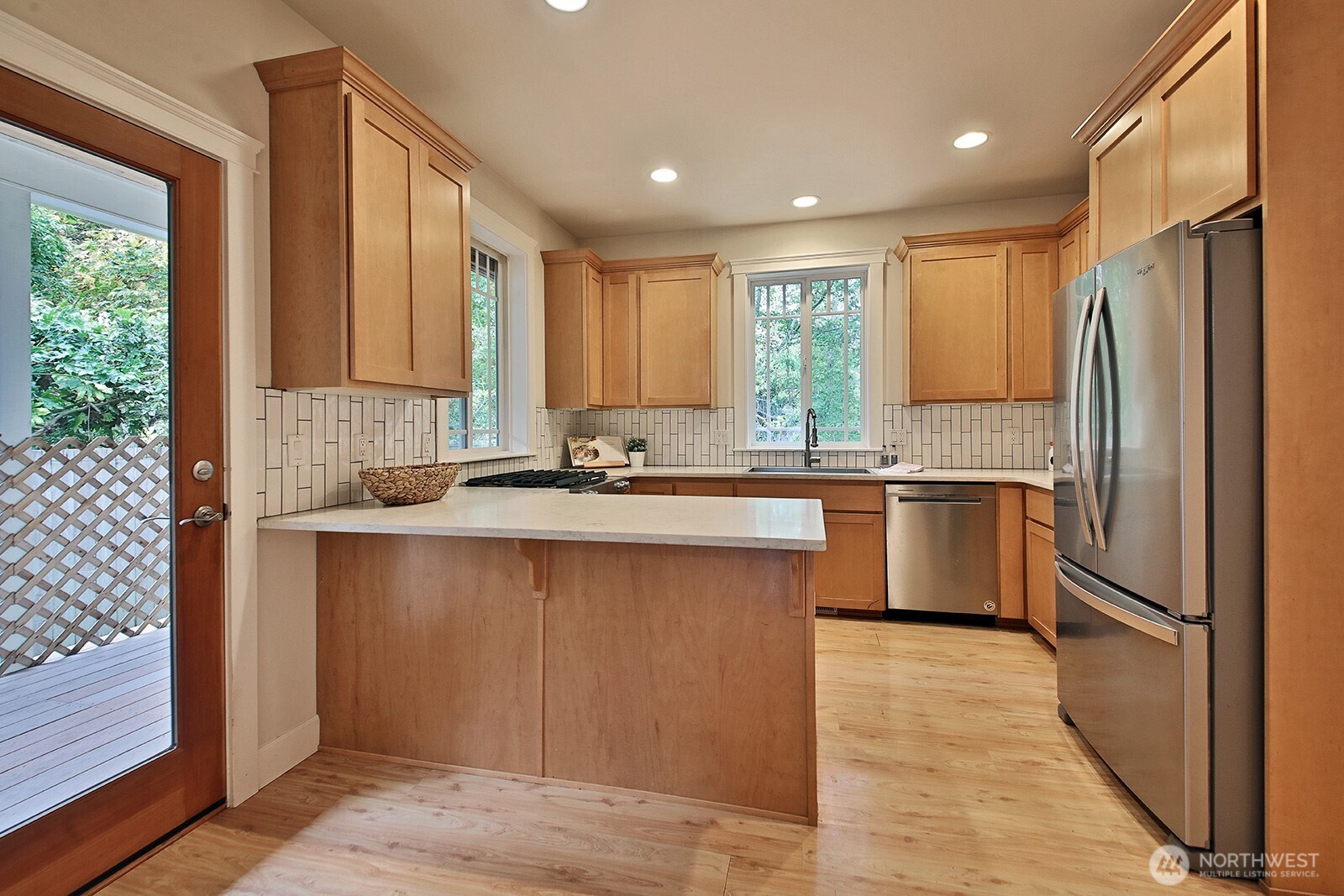 1821 Watkins Road Freeland, WA 98249 - Photo 8 of 28 a kitchen with stainless steel appliances granite countertop a refrigerator a sink a stove and white cabinets with wooden floor