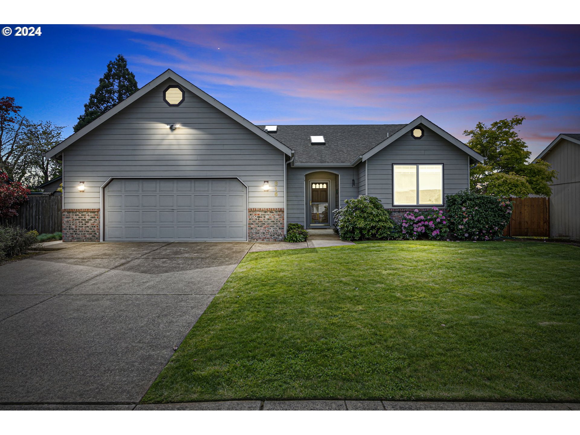 a front view of a house with a yard and garage