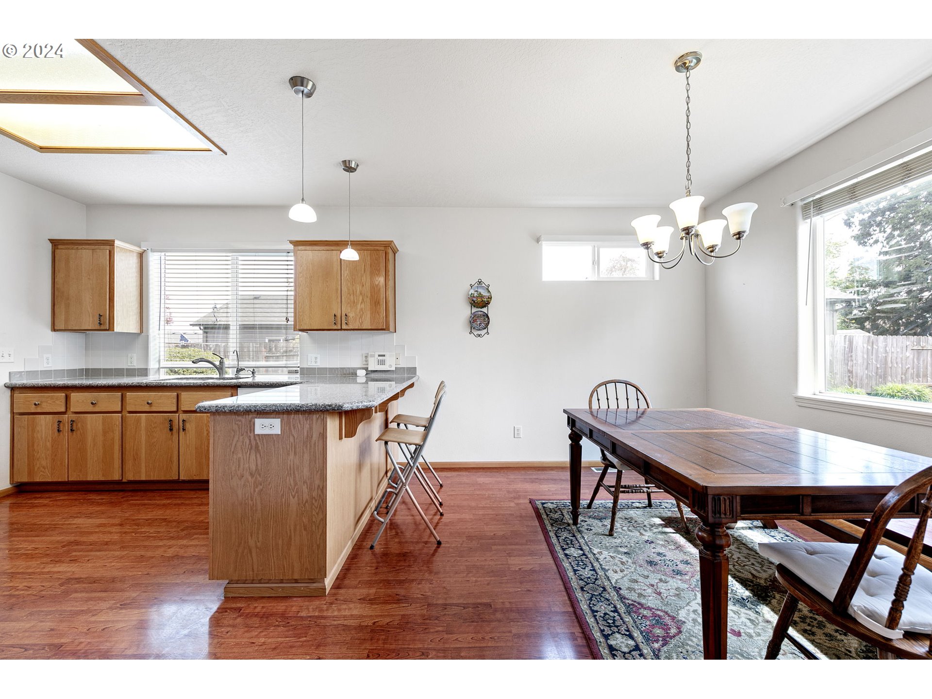 815 R Street Springfield, OR 97477 - Photo 15 of 37 a dining room dining table chairs wooden floor and a chandelier