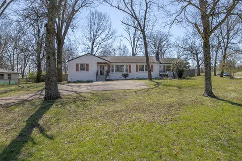 a house that has a tree in front of it
