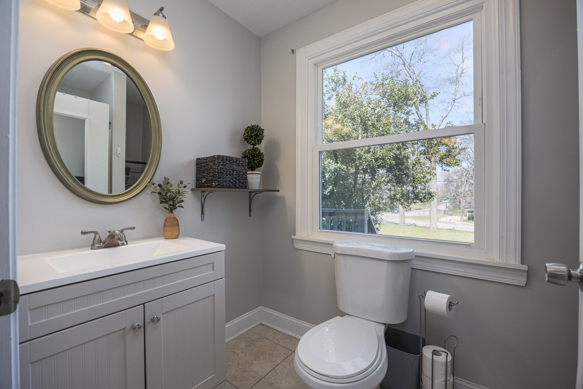 500 Vantrease Road Madison, TN 37115 - Photo 17 of 24 a bathroom with a toilet a sink a mirror and a window