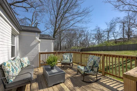 a view of a balcony with couch on wooden floor