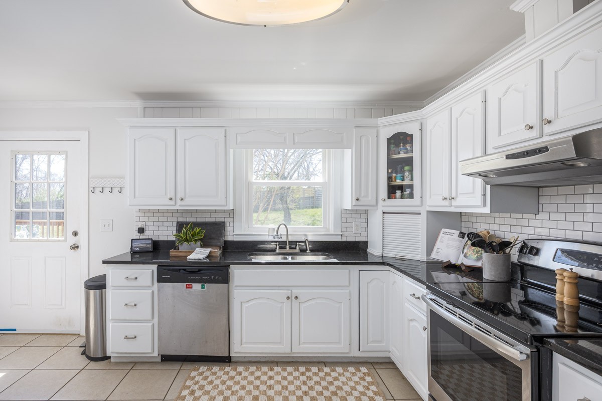 500 Vantrease Road Madison, TN 37115 - Photo 6 of 24 a kitchen with white cabinets appliances a sink and a window