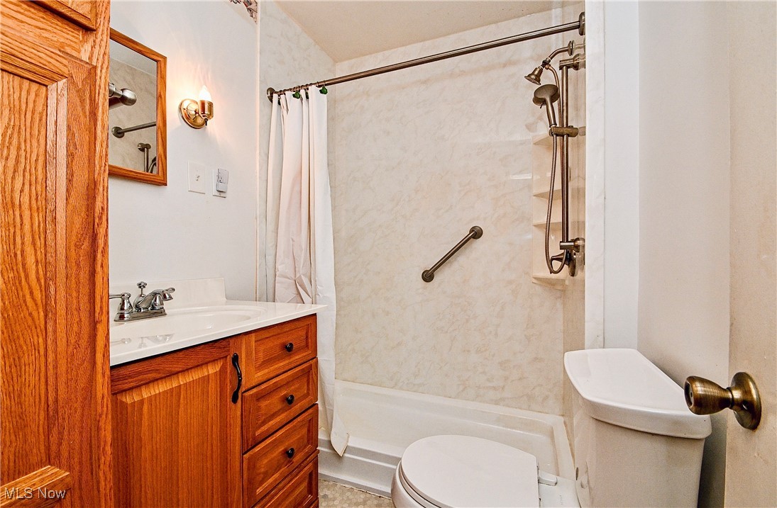 630 Neal Road Akron, OH 44312 - Photo 15 of 15 Bathroom featuring a shower with curtain, vanity, and toilet