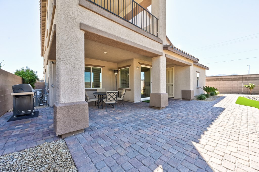 1054 Langston Ranch Avenue Henderson, NV 89002 - Photo 12 of 82 Patio, Covered patio, BBQ Area for grilling and outdoor entertaining. Ground mounted HVAC system on side of home.