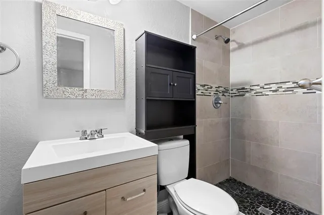 a bathroom with a sink toilet and shower