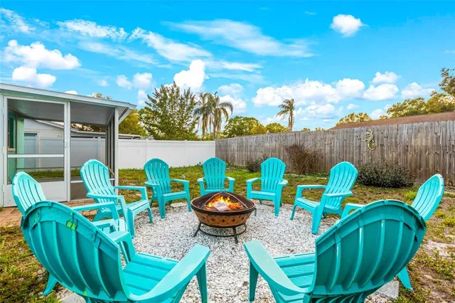 a view of an outdoor sitting area in a backyard