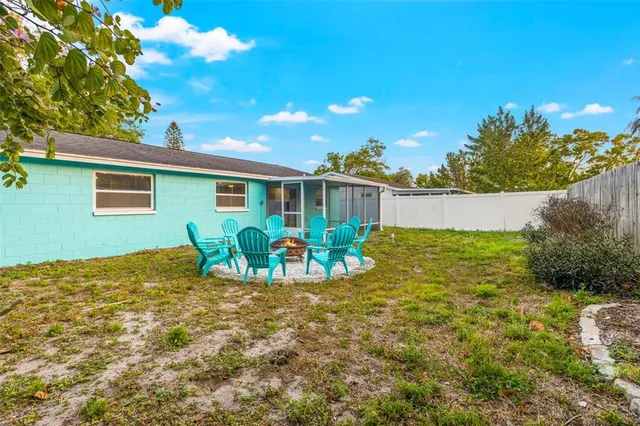 a view of a house with backyard and sitting area
