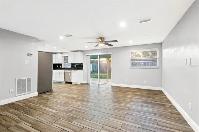 a view of a kitchen with furniture and wooden floor
