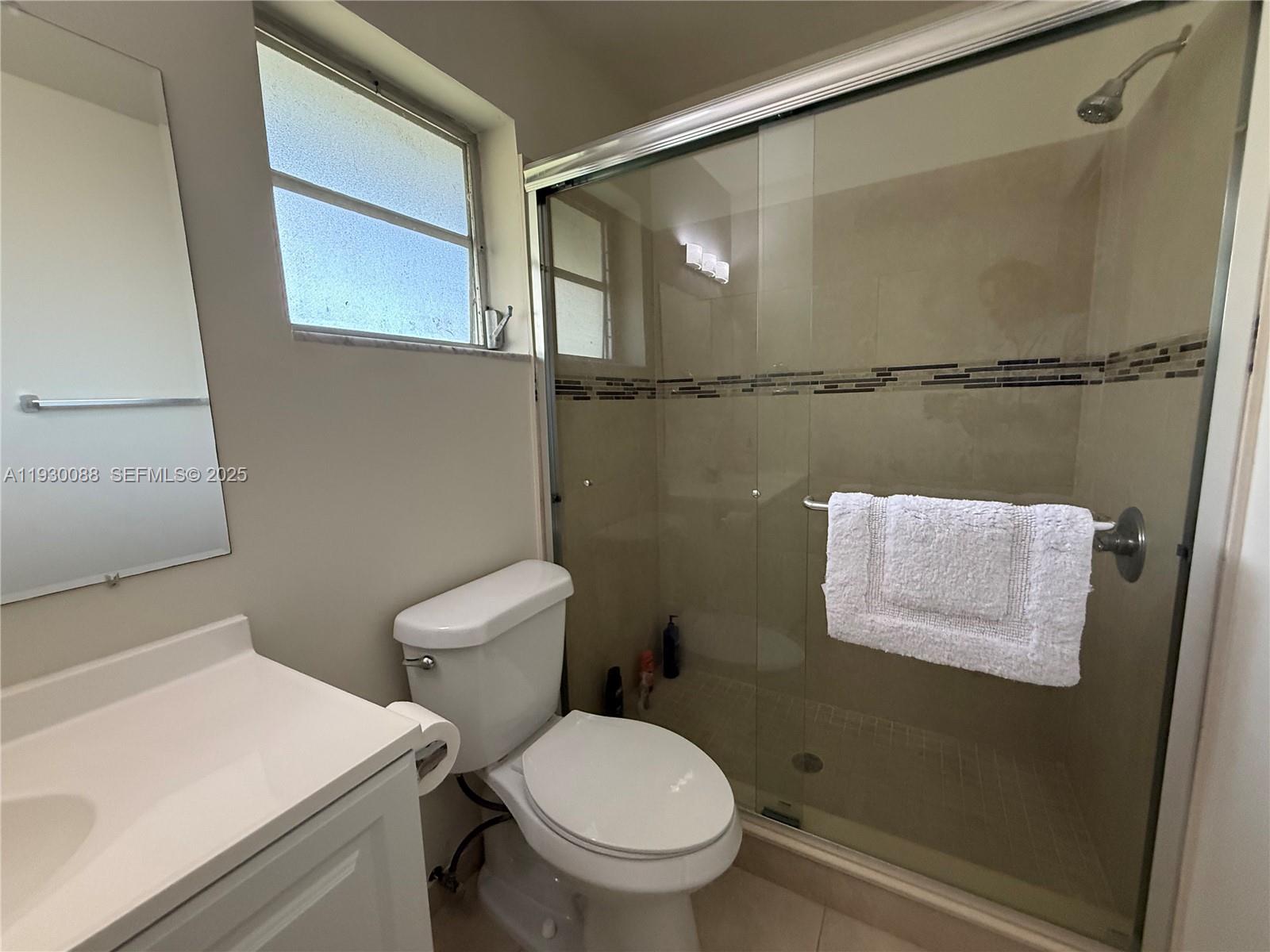 900 Tallwood Avenue, Unit 306 Hollywood, FL 33021 - Photo 13 of 30 a bathroom with a toilet and a sink