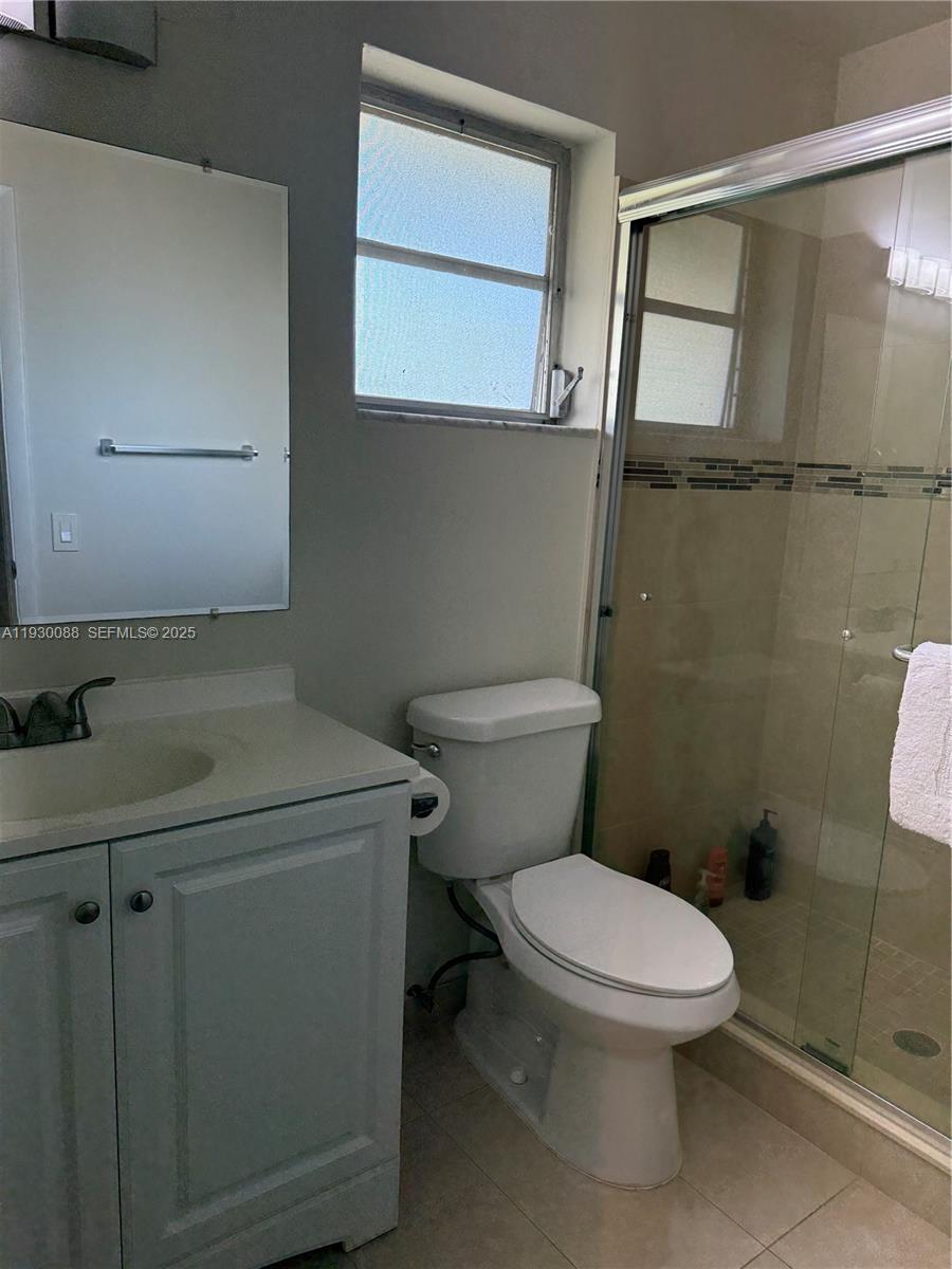 900 Tallwood Avenue, Unit 306 Hollywood, FL 33021 - Photo 15 of 30 a white toilet sitting next to a bathroom sink