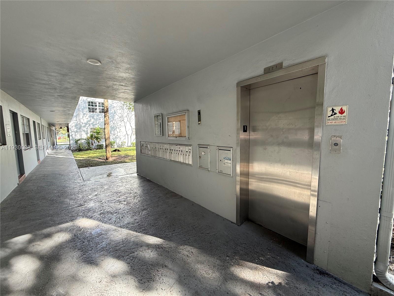 900 Tallwood Avenue, Unit 306 Hollywood, FL 33021 - Photo 25 of 30 a view of a hallway to an empty room and window