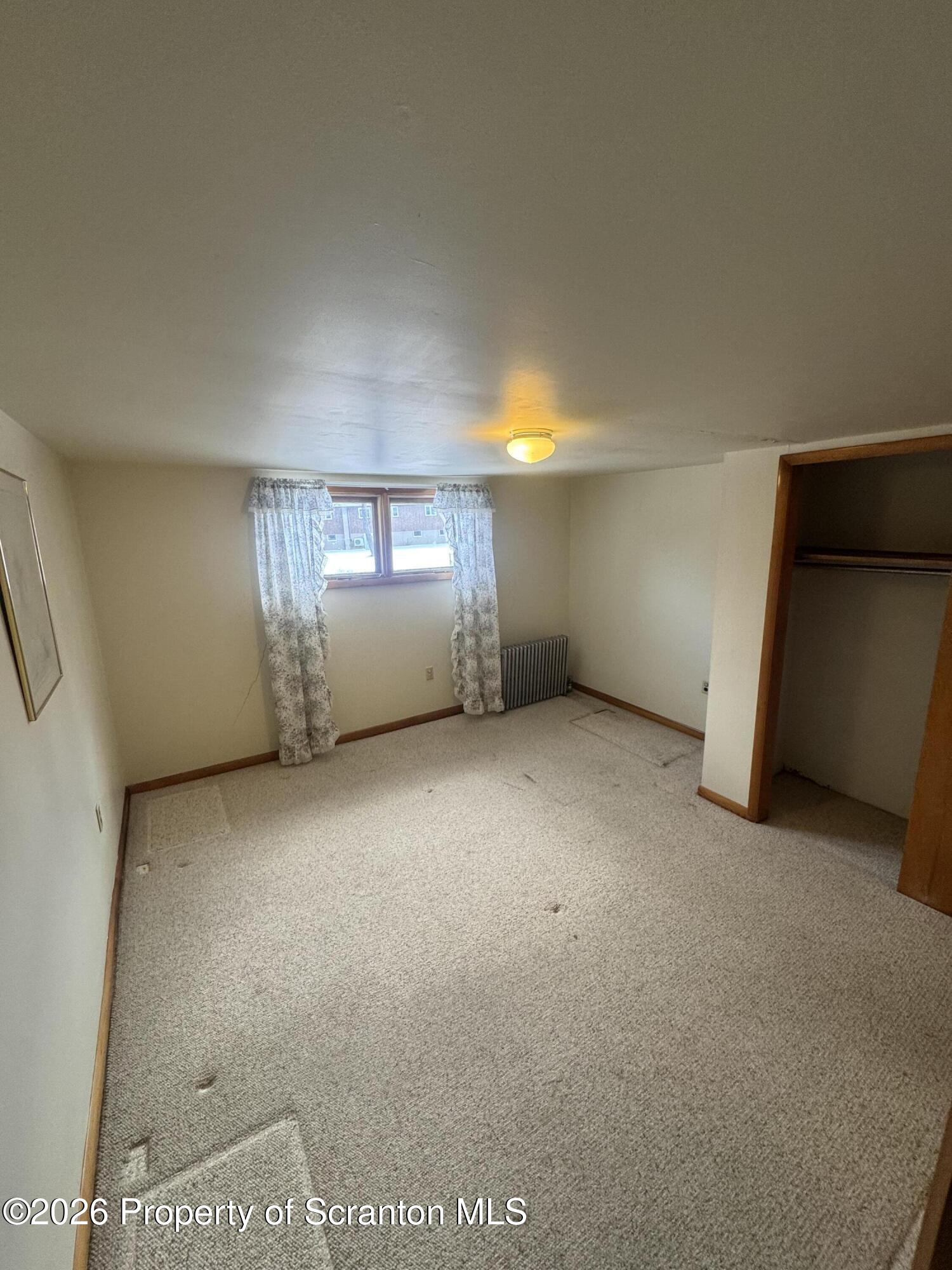 203 Laurel Street Archbald, PA 18403 - Photo 17 of 28 wooden floor and window in an empty room
