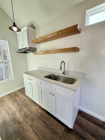 a kitchen with a sink and cabinets