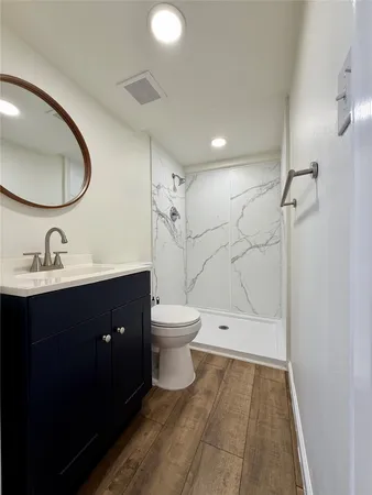 a bathroom with a sink a toilet and a mirror