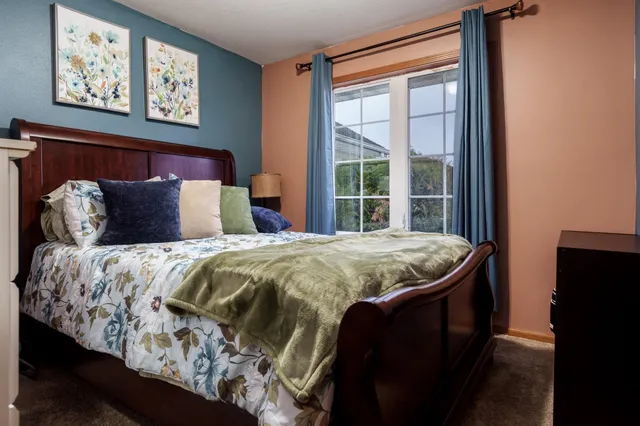 a bathroom with a granite countertop sink toilet and mirror
