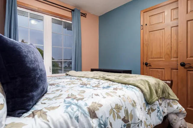 a bedroom with a bed window and a table