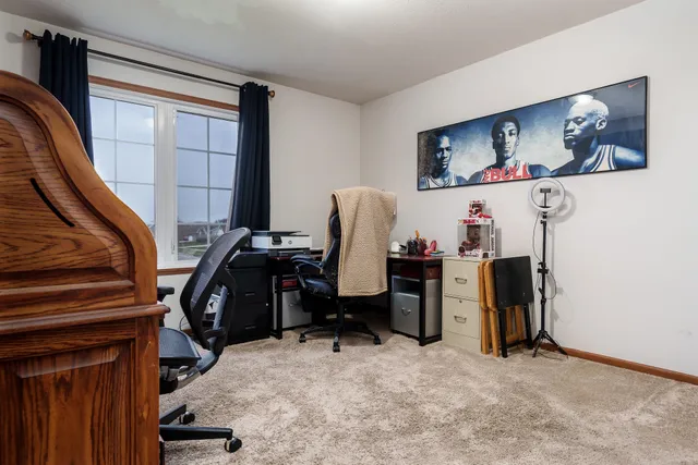 a bedroom with a bed and a flat tv screen on dresser