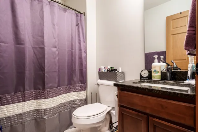 a view of walk in closet with clothes