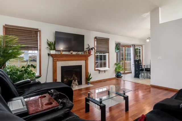 a living room with furniture a flat screen tv and a fireplace