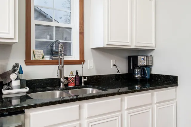 a kitchen with stove and cabinets