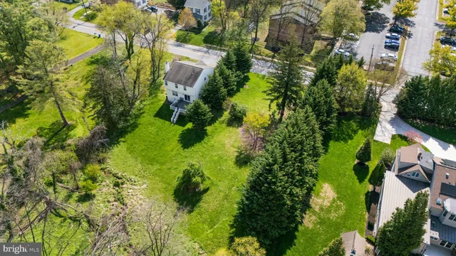 an aerial view of residential house with swimming pool and green space