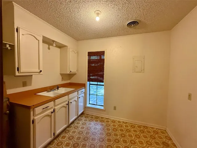 a kitchen with a sink and cabinets