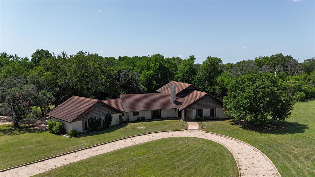 998 Highway 22 Hamilton, TX 76531 - Photo 22 of 40 a aerial view of a house with a yard table and trees