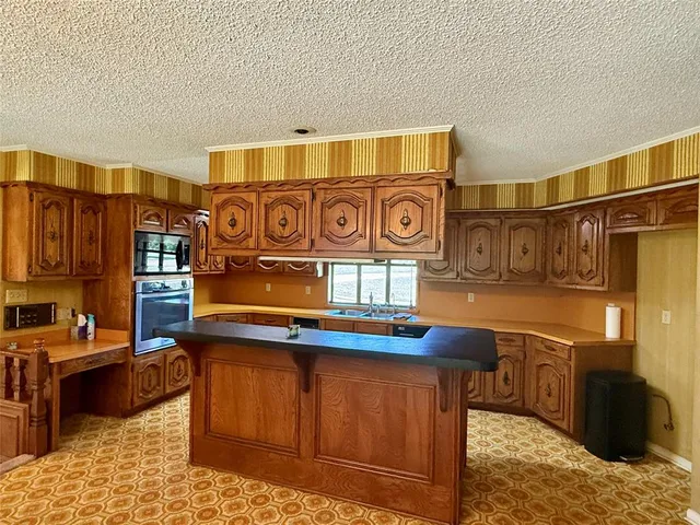 a kitchen with stainless steel appliances granite countertop a sink and cabinets