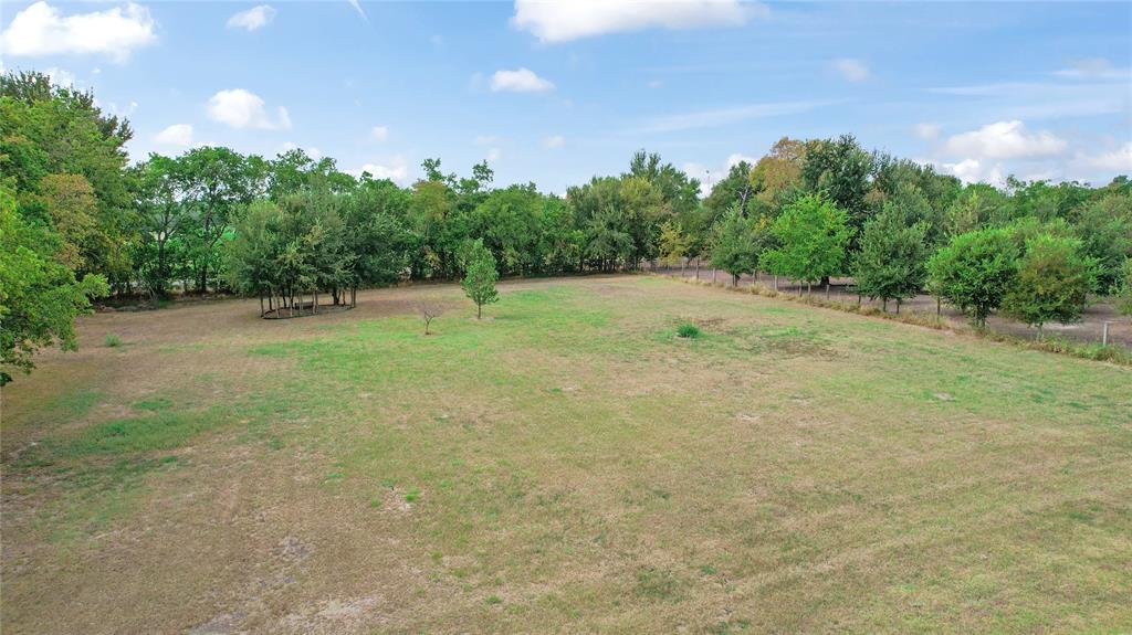 7944 County Road 669 Blue Ridge, TX 75424 - Photo 33 of 37 a backyard of a house with plants and large trees