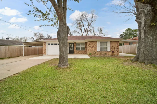 a view of a house with backyard sitting area and garden